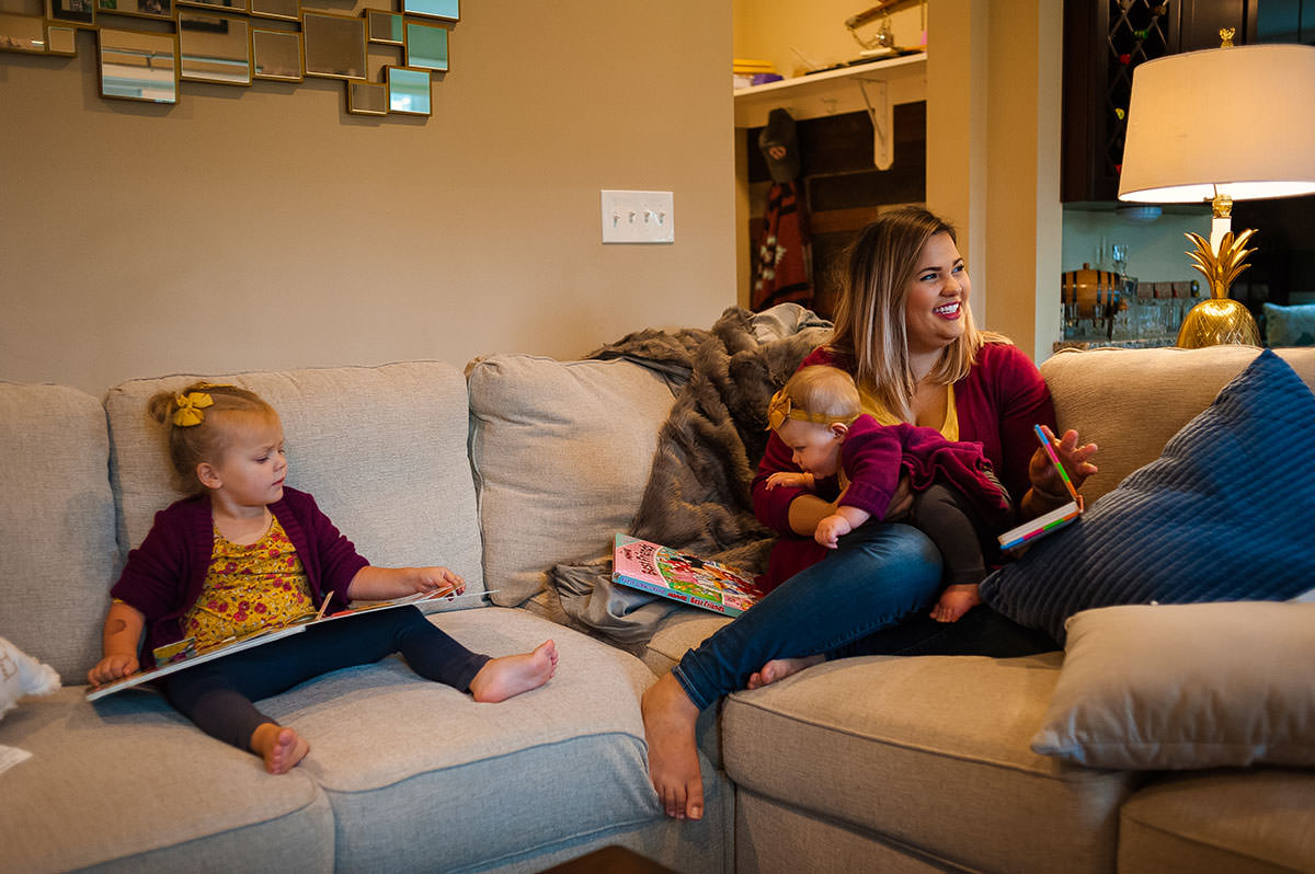 girls sitting and reading on couch