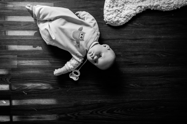 Annabelle's doll lays forgotten on the floor.