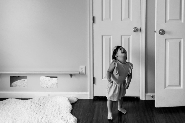 Annabelle laughs and giggles as she twirls around in Selah's room.