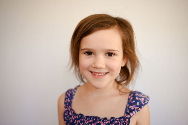 Girl wears a floral dress for preschool portraits.