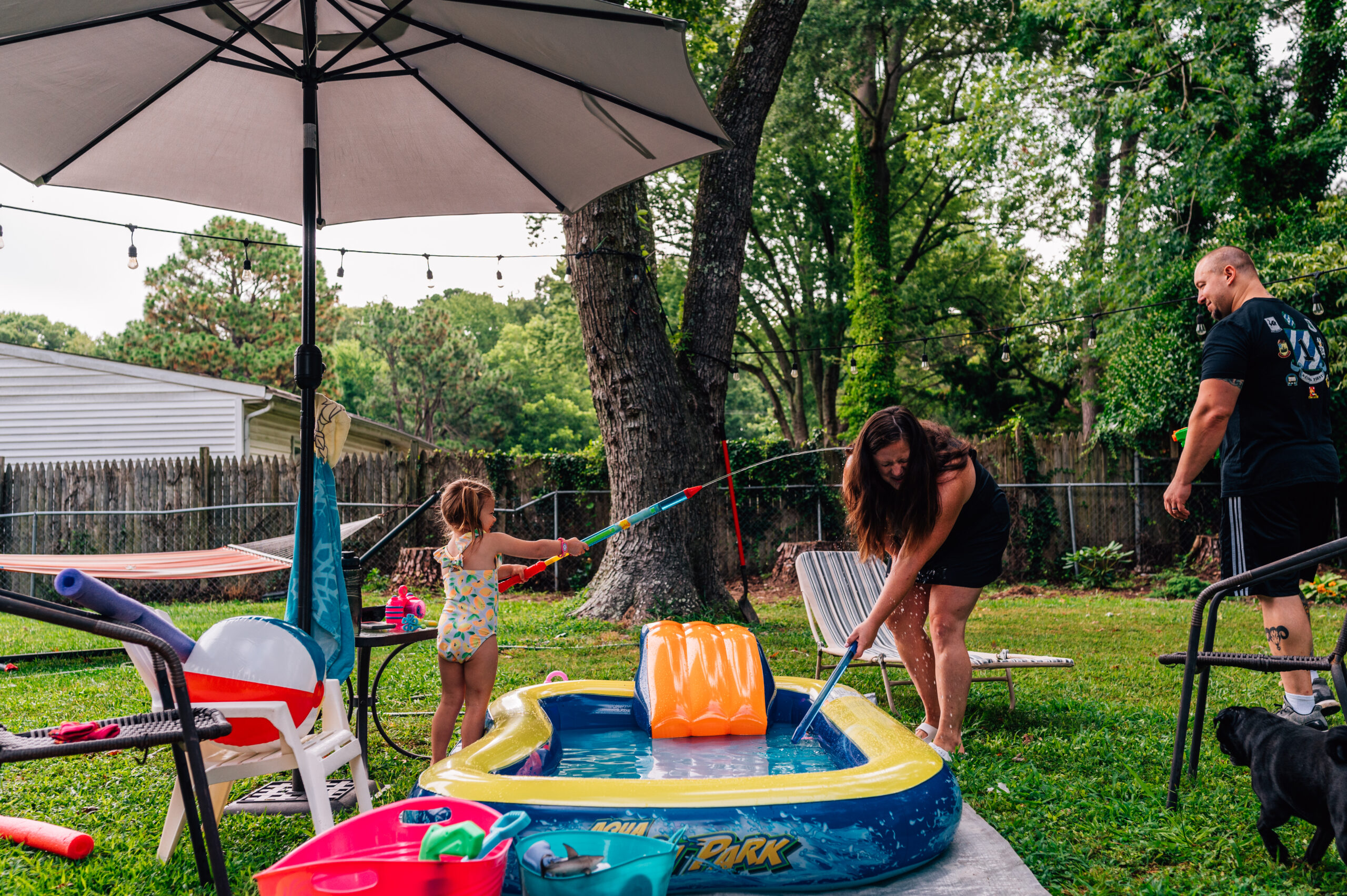 Ceci squirts her mother with a water gun during their mini story family session in Newport News, Va.
