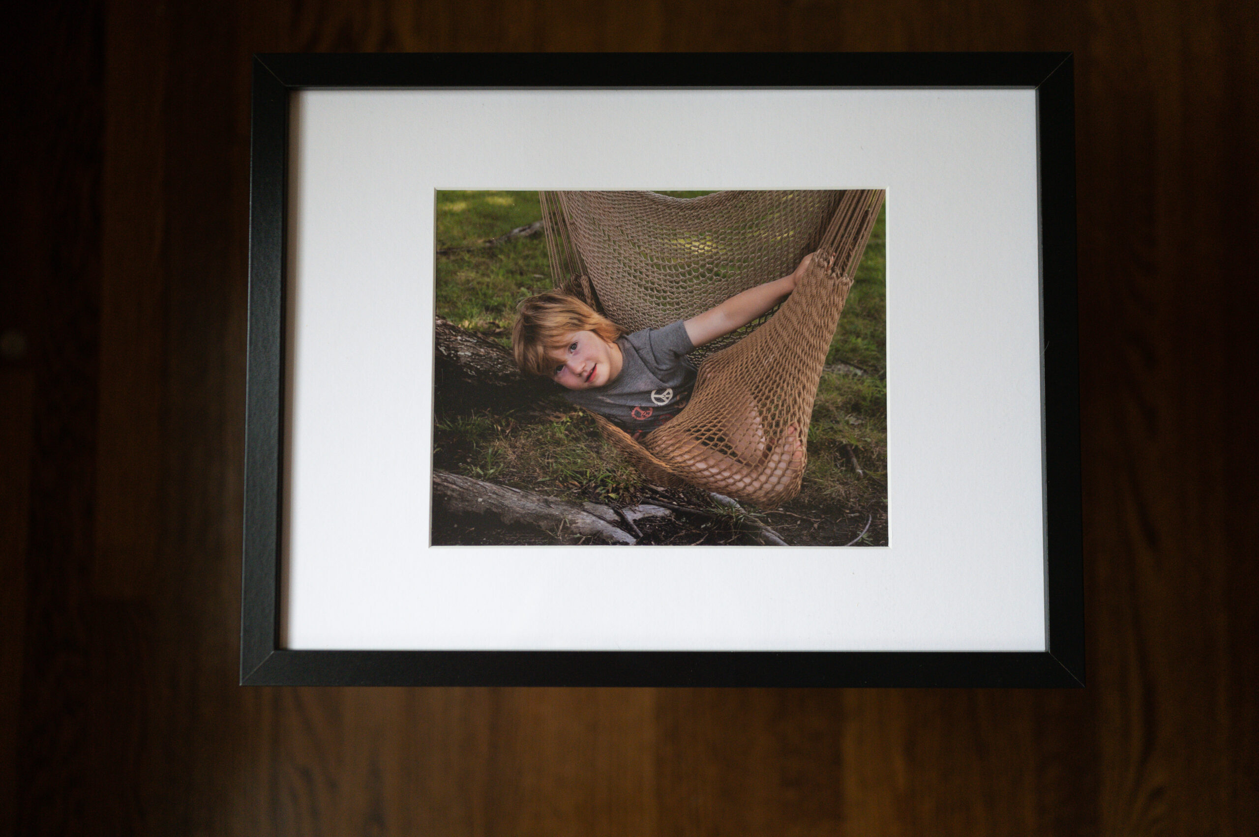 Classic black framed print of Emmett in hammock during their family session at home in Newport News, Virginia.