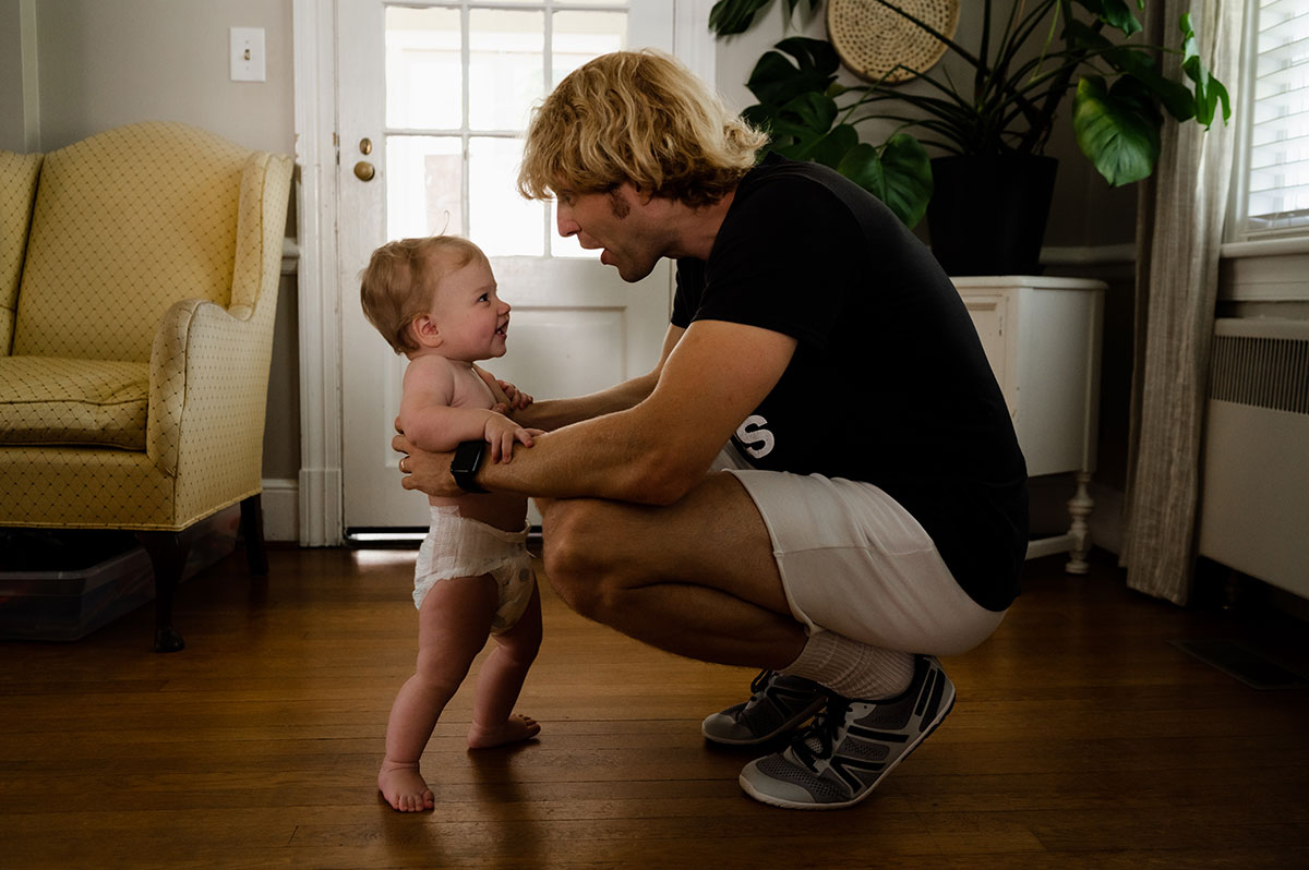 David makes a face as baby Carter looks up at him enduringly captured by Virginia Beach photographer, Dreama Spence.