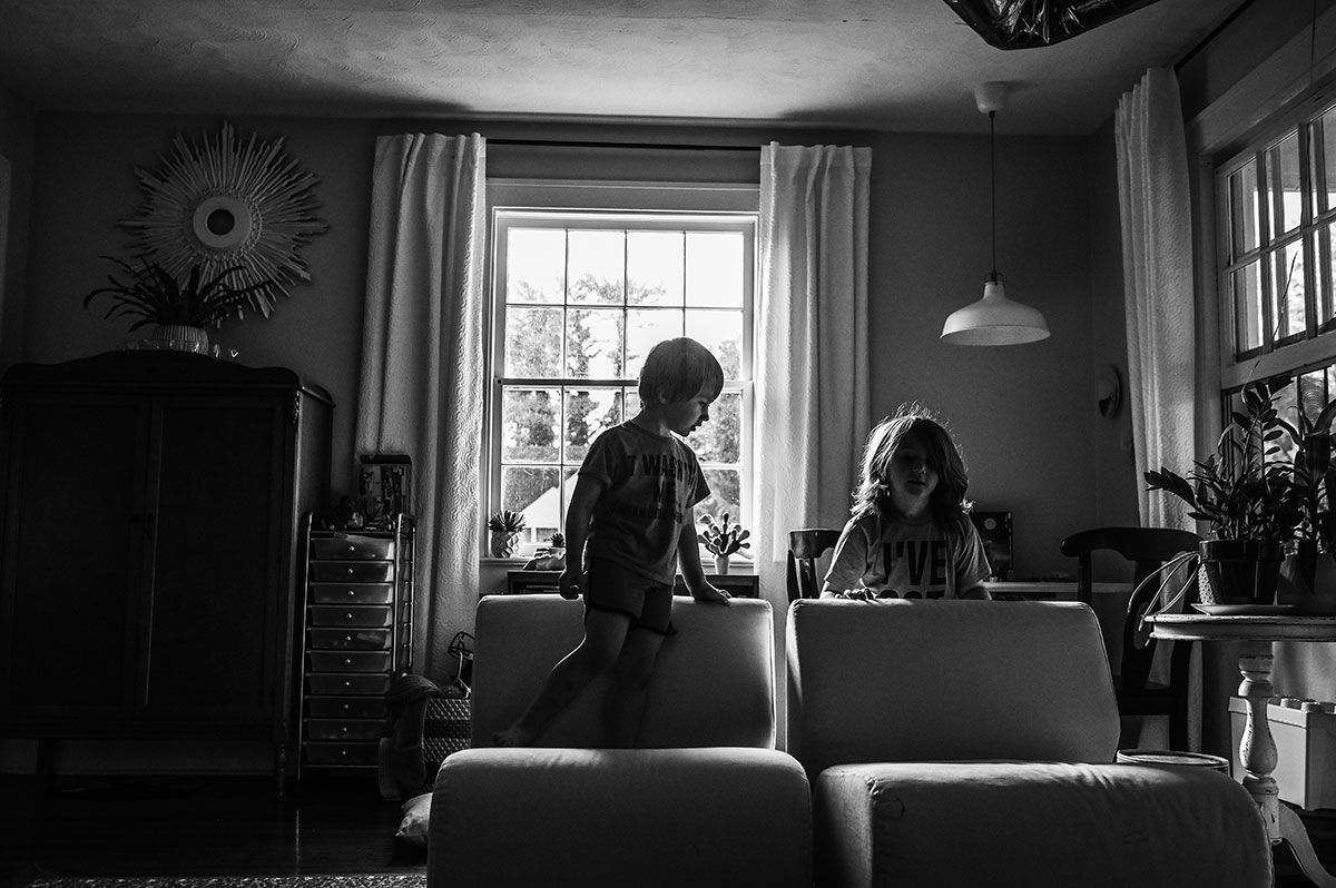 Calvin and Emmet play floor is lava during their in-home family session.