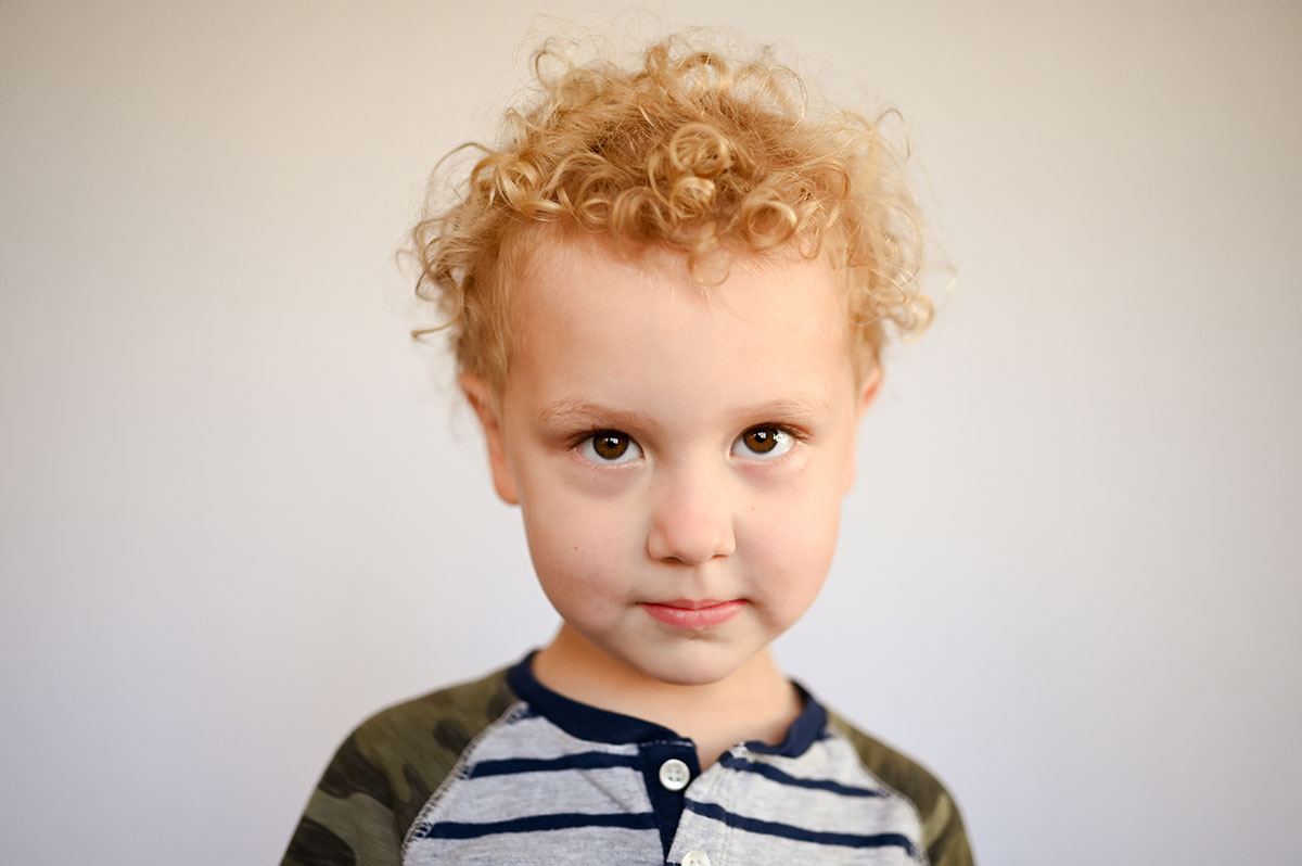 Auggie gives a sweet, shy look during preschool portraits.