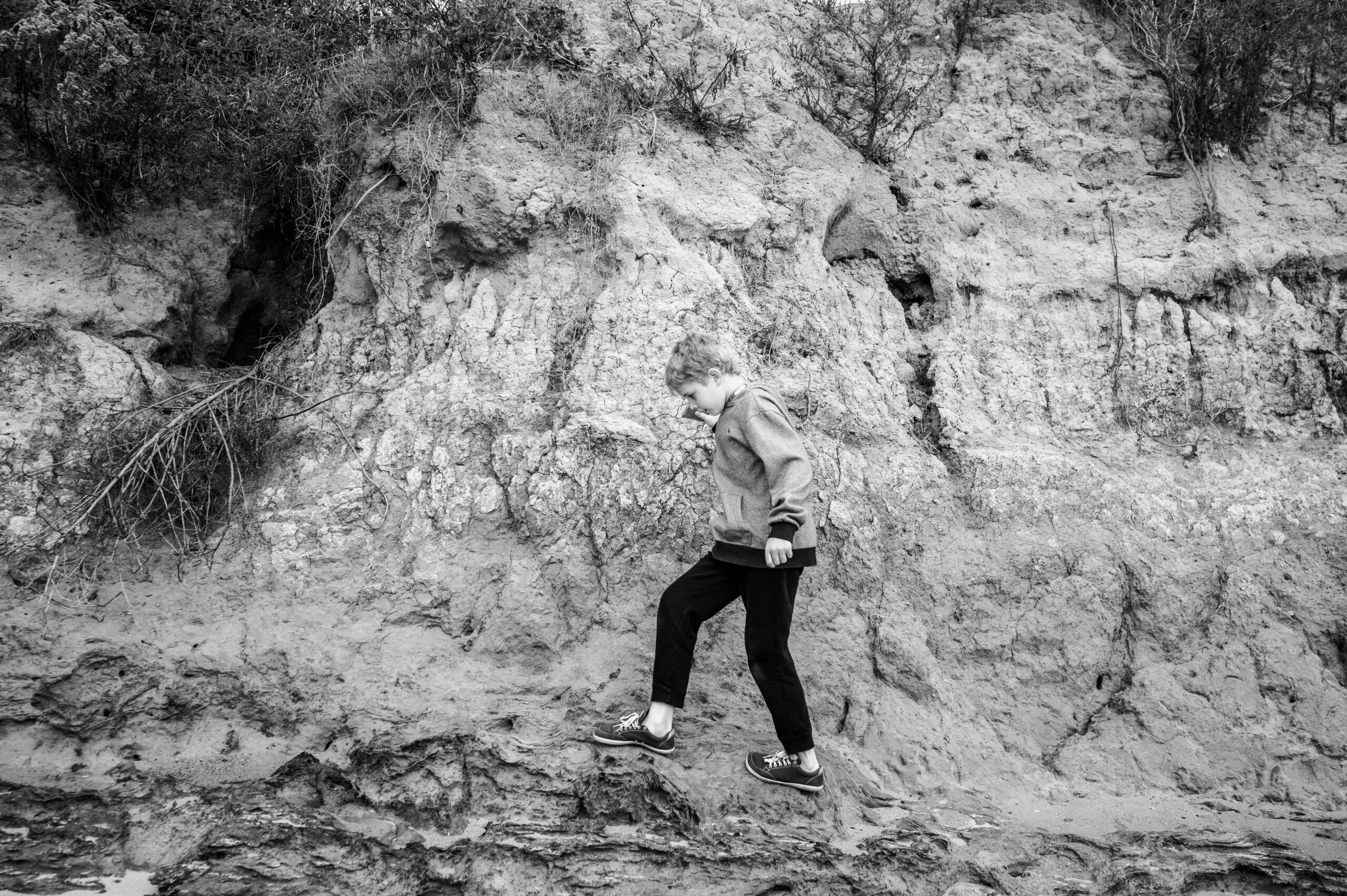 Boy explores the cliff beach near Lions Bridge in Newport News.