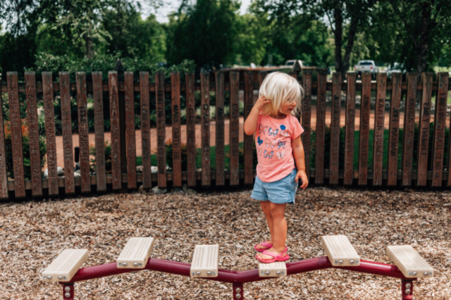 Little girl walks on play equipment at River View Farm Park in Newport News, Virginia.