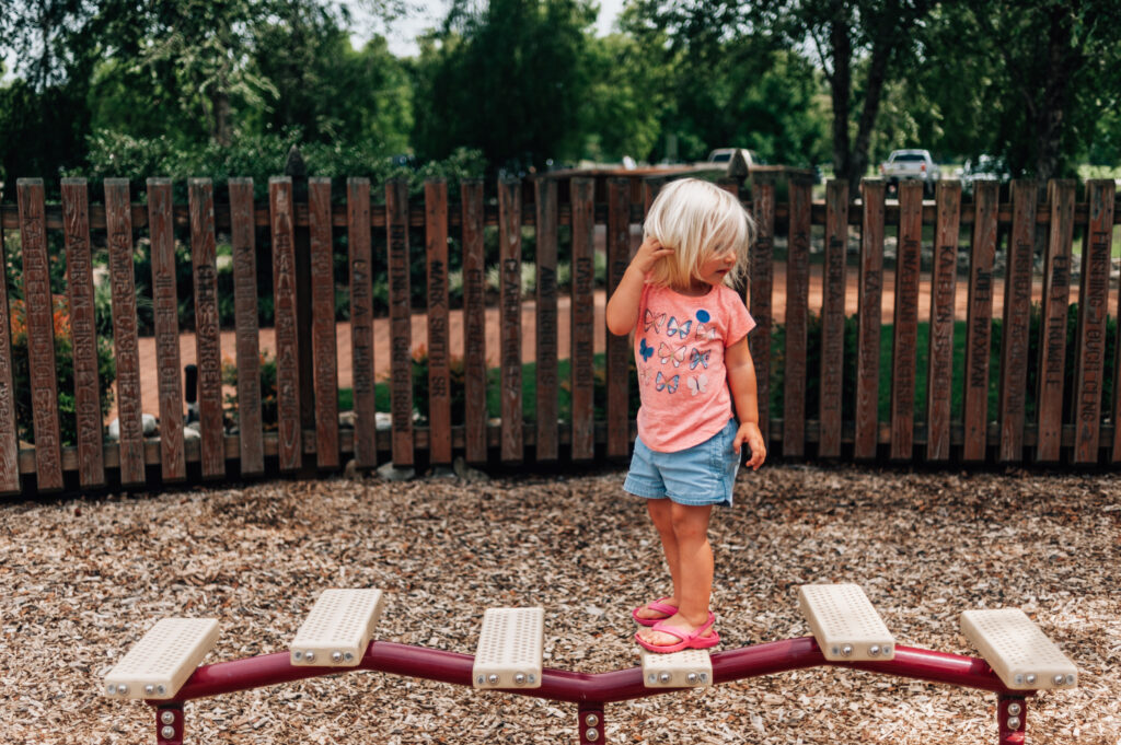 Little girl walk on play equipment at River View Farm Park in Newport News, Va.