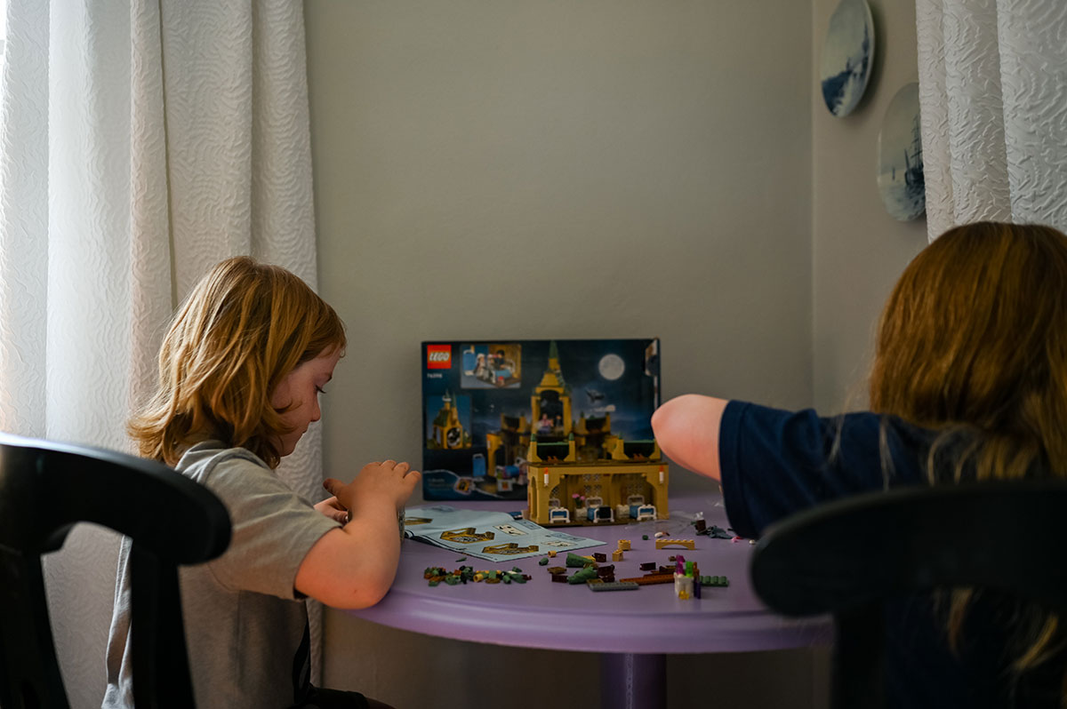 Kids put together Harry Potter Lego set.