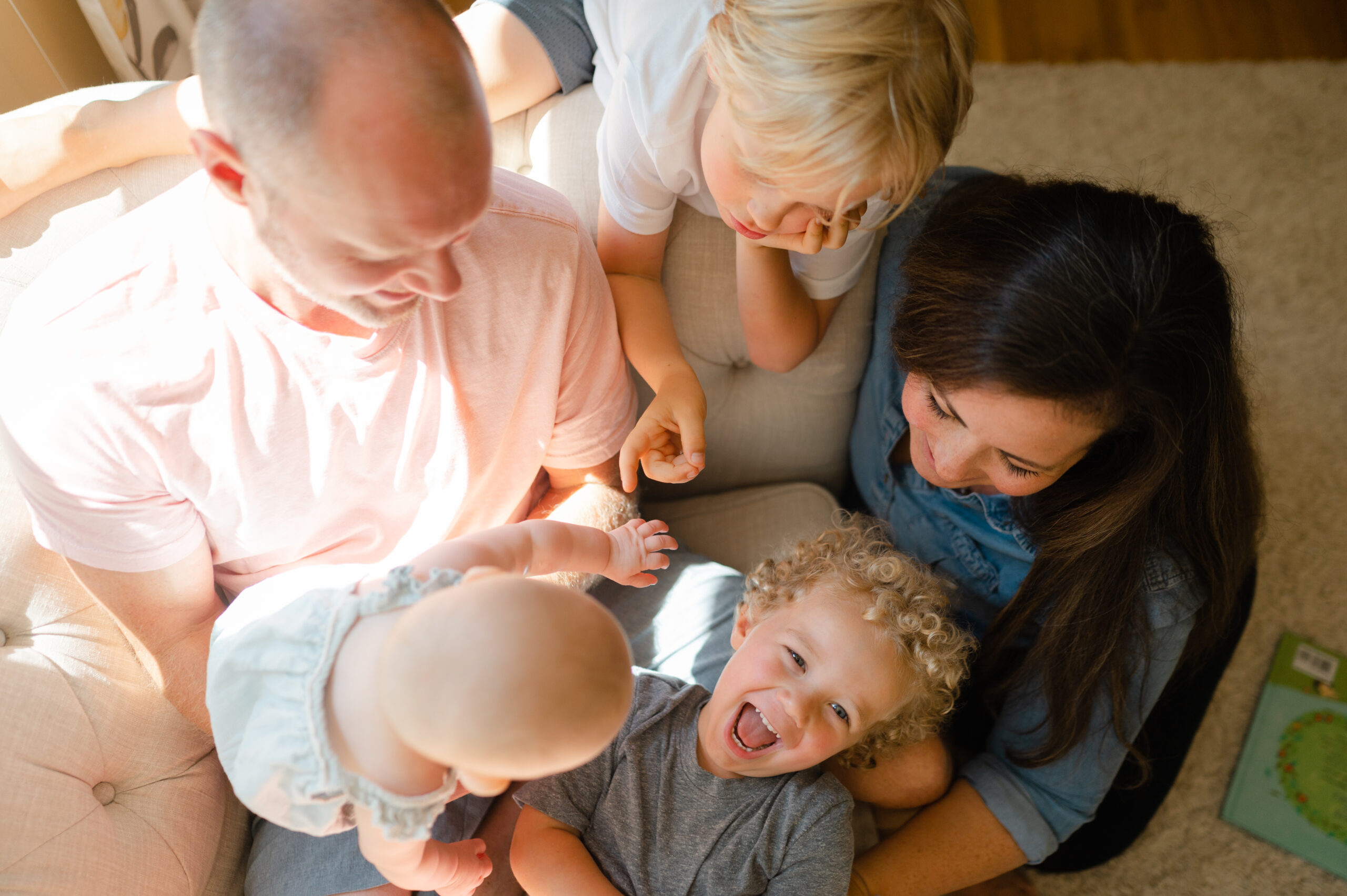 Family huddled together in living room.