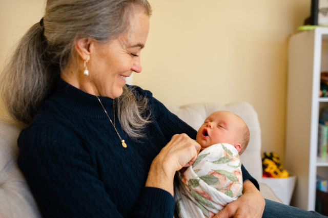 Grandmother smiles at her newest grandchild.