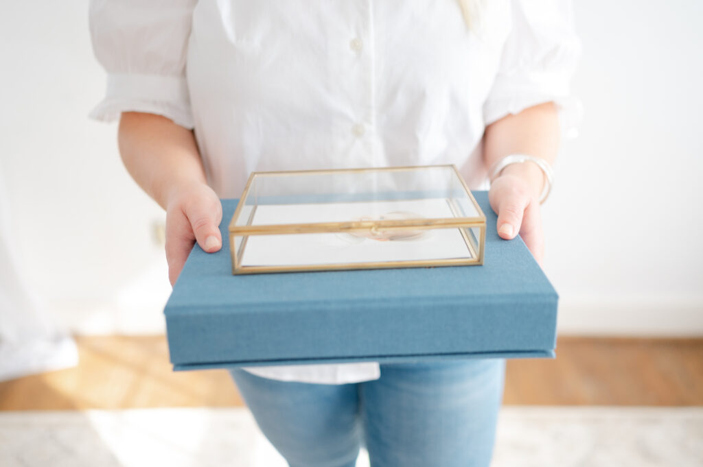 Dreama holds a print box and a linen photo box.