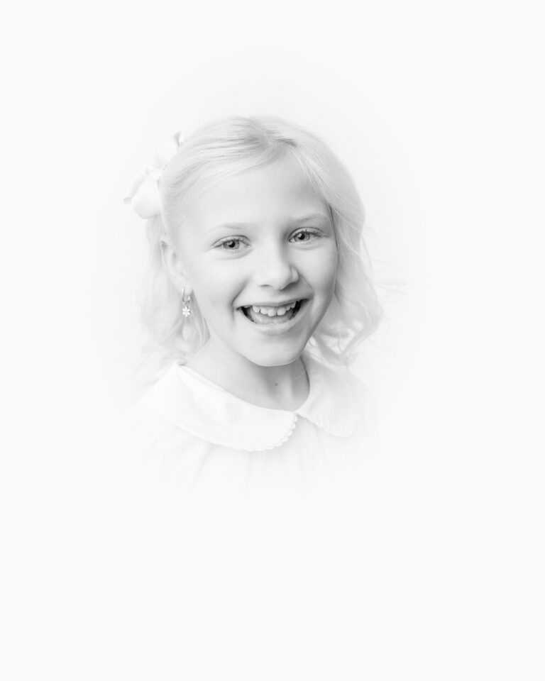 Heirloom Portraits near me. Portrait of little girl in collared white shirt.