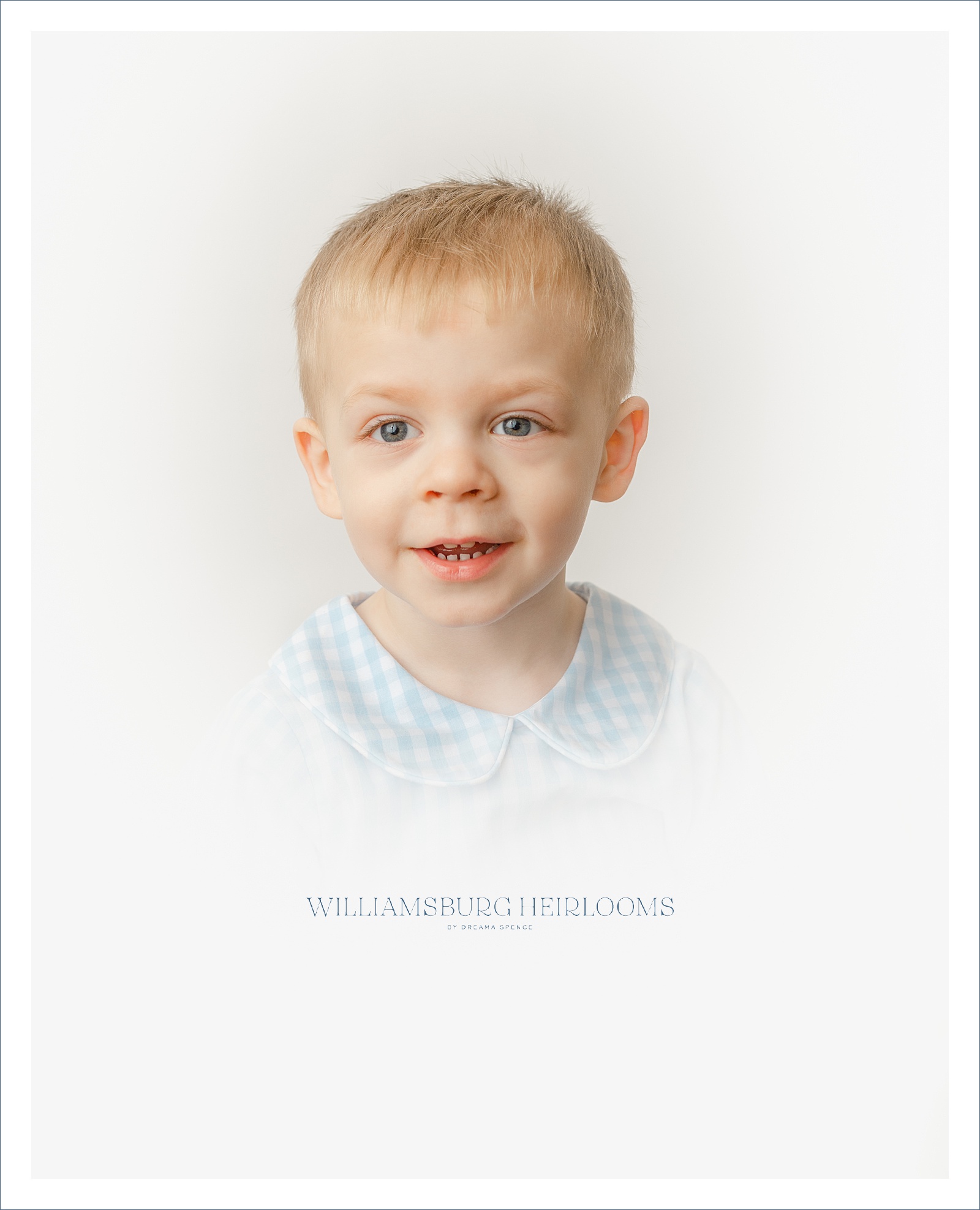 Heirloom vignette portrait of boy in white and blue checkered outfit.