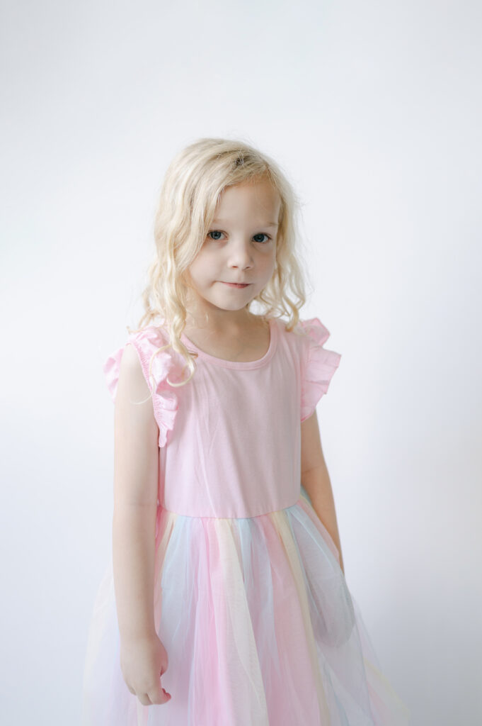 Little girl wears a beautiful tulle dress during school portrait.