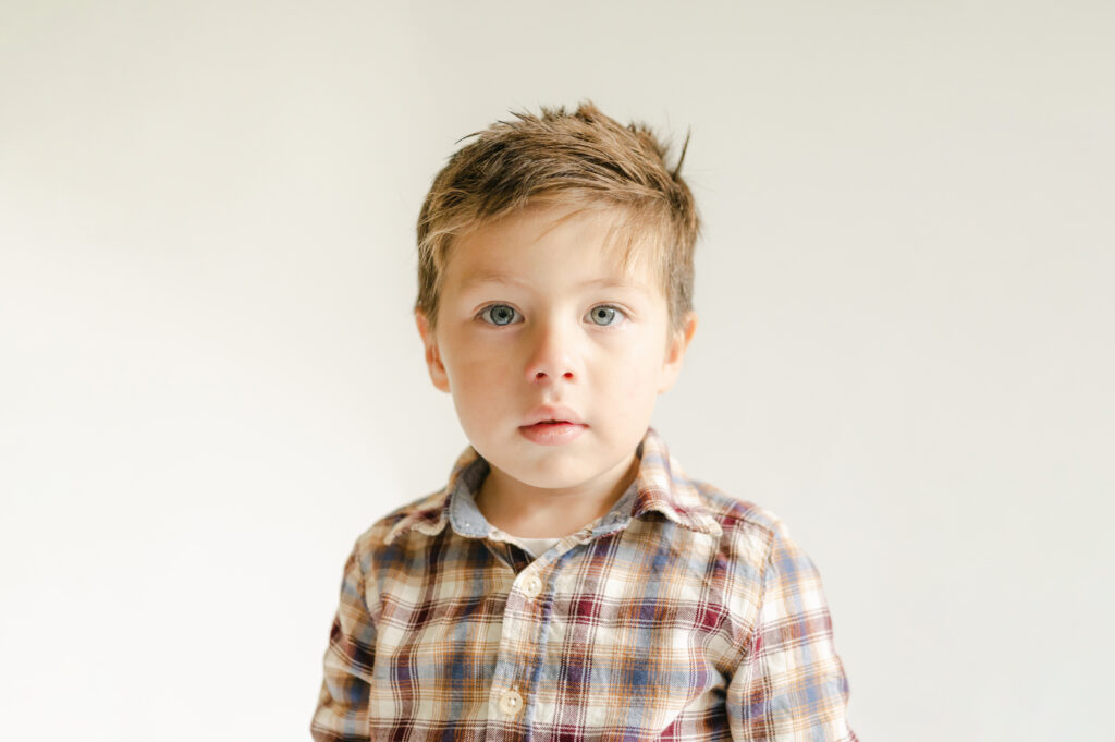 Boy wears plaid during his fall school portrait.