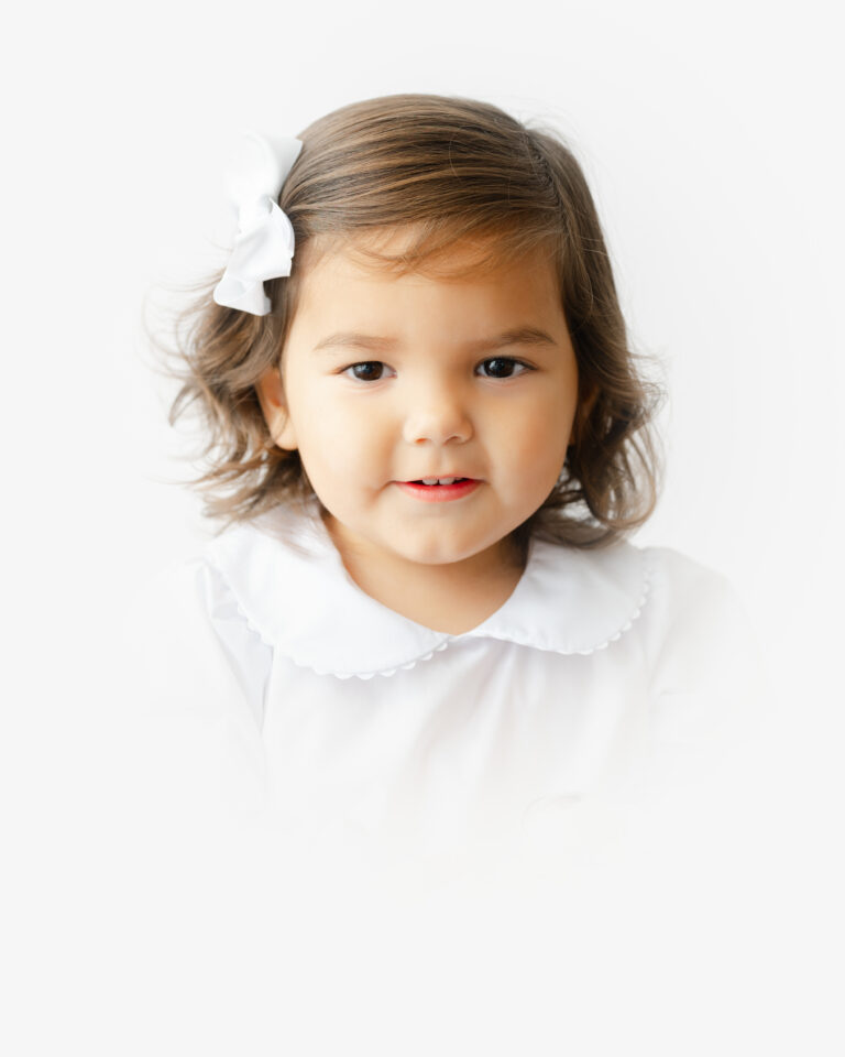 Little girl smiles during her heirloom portrait session in Williamsburg.