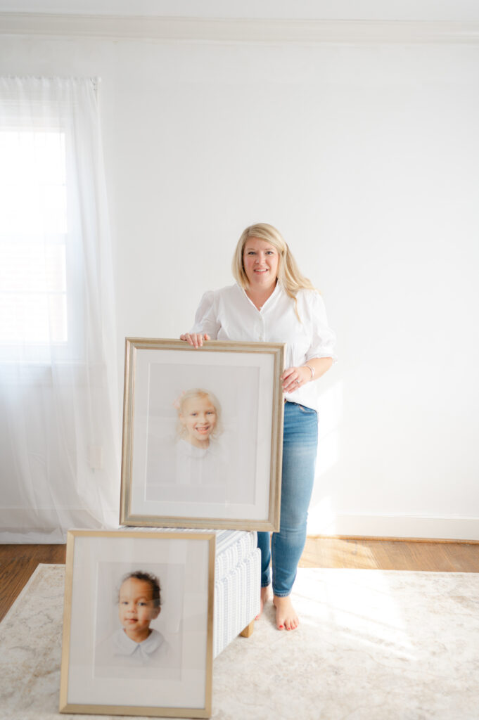 Dreama poses with a framed heirloom portrait.