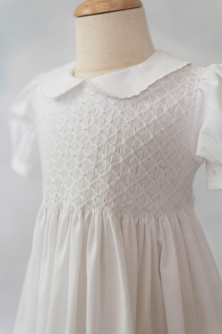 Up close details of a smocked Feltman Brothers dress.