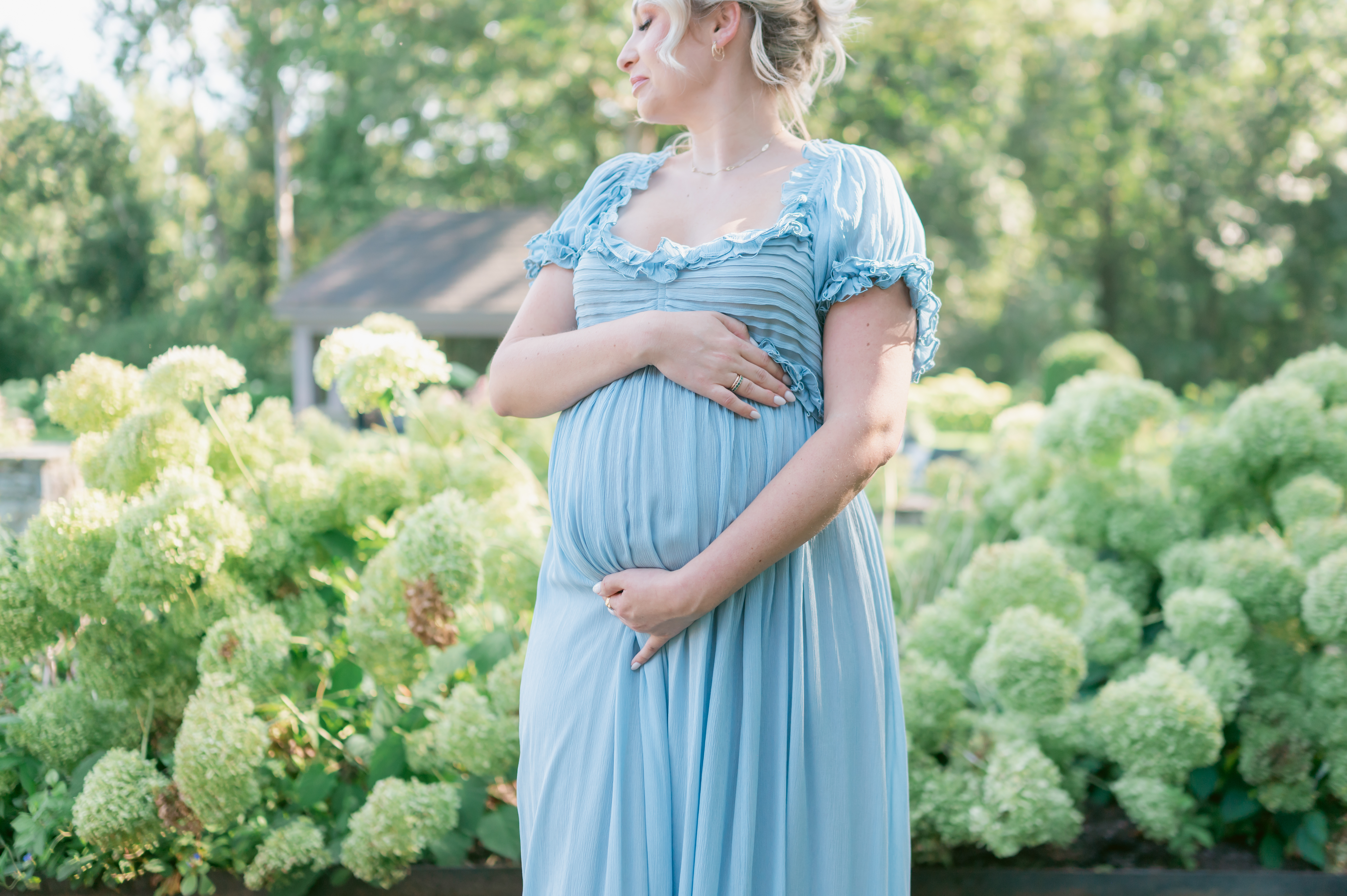 Maternity photography in Virginia Beach Virginia featuring expecting mother in garden setting with natural light.