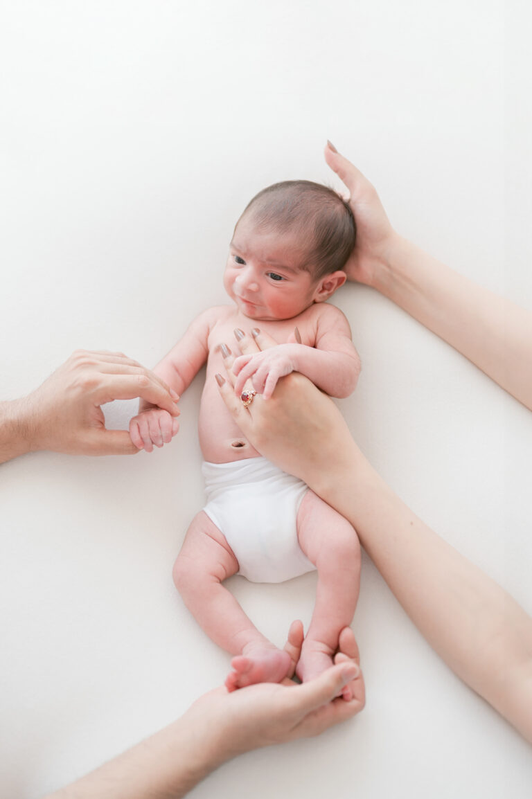 Norfolk Virginia photographer creating elegant family portraits featuring mom, dad, and baby.