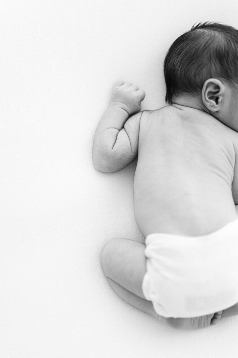 Detail shot of newborn’s back wrinkles during newborn photography in Norfolk, Virginia.