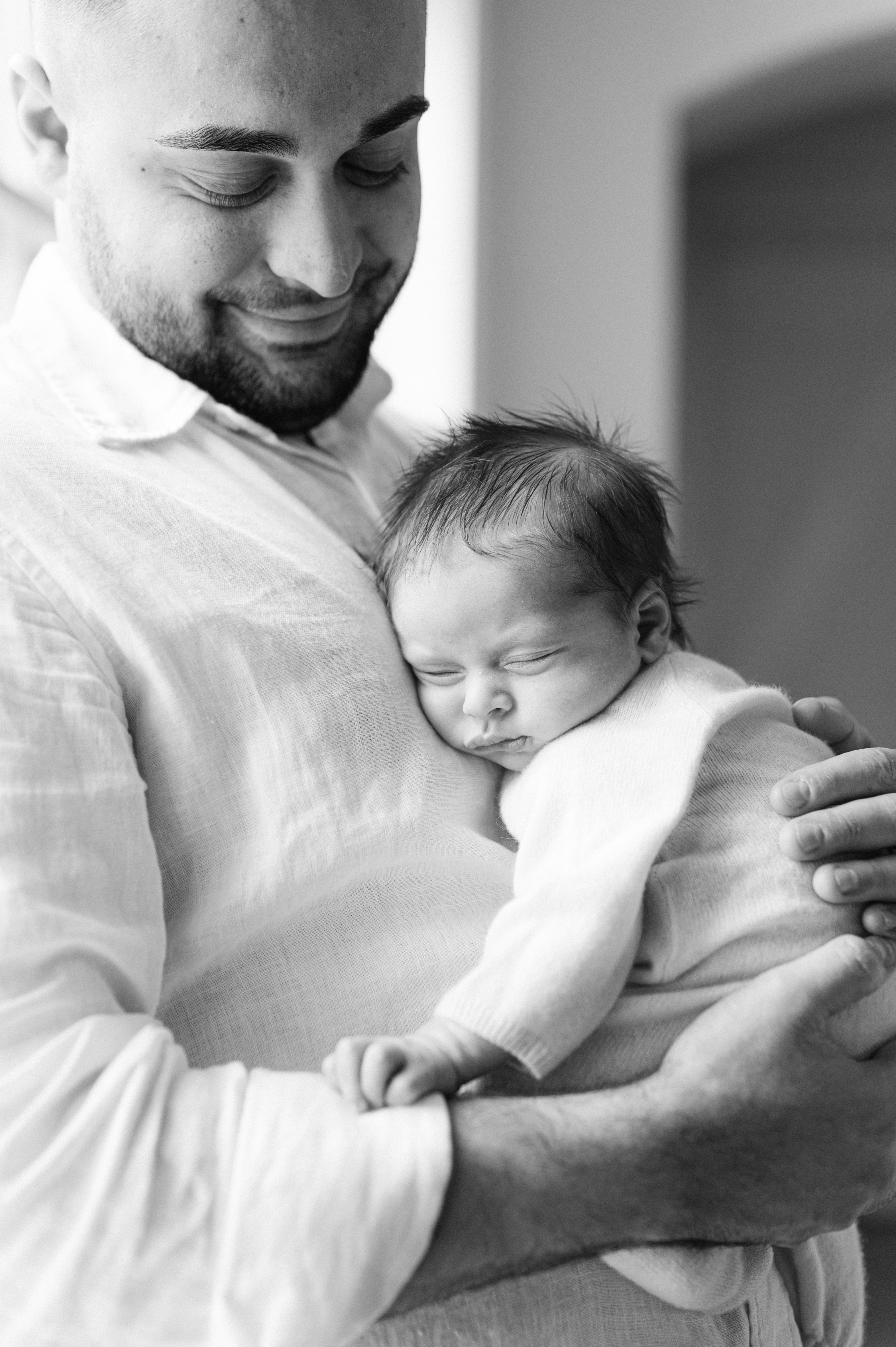 norfolk-in-home-newborn-photographer-dad-holding-baby-069