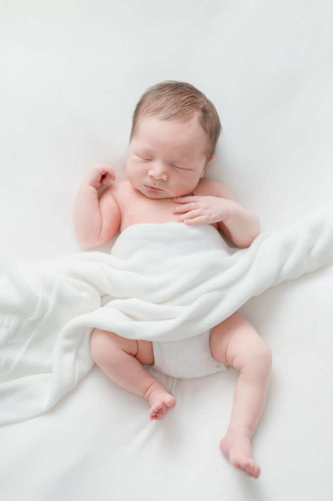 Baby sleeping peacfully and loosely wrapped during session