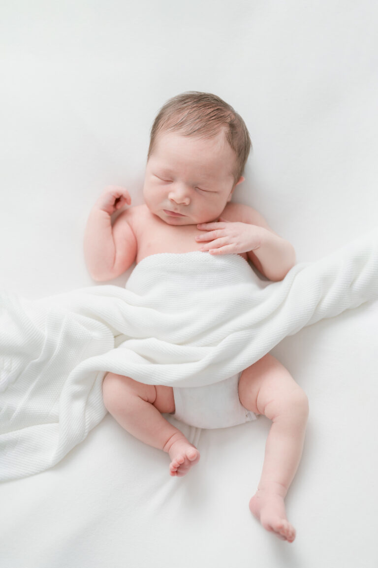 Baby sleeping peacfully and loosely wrapped during session