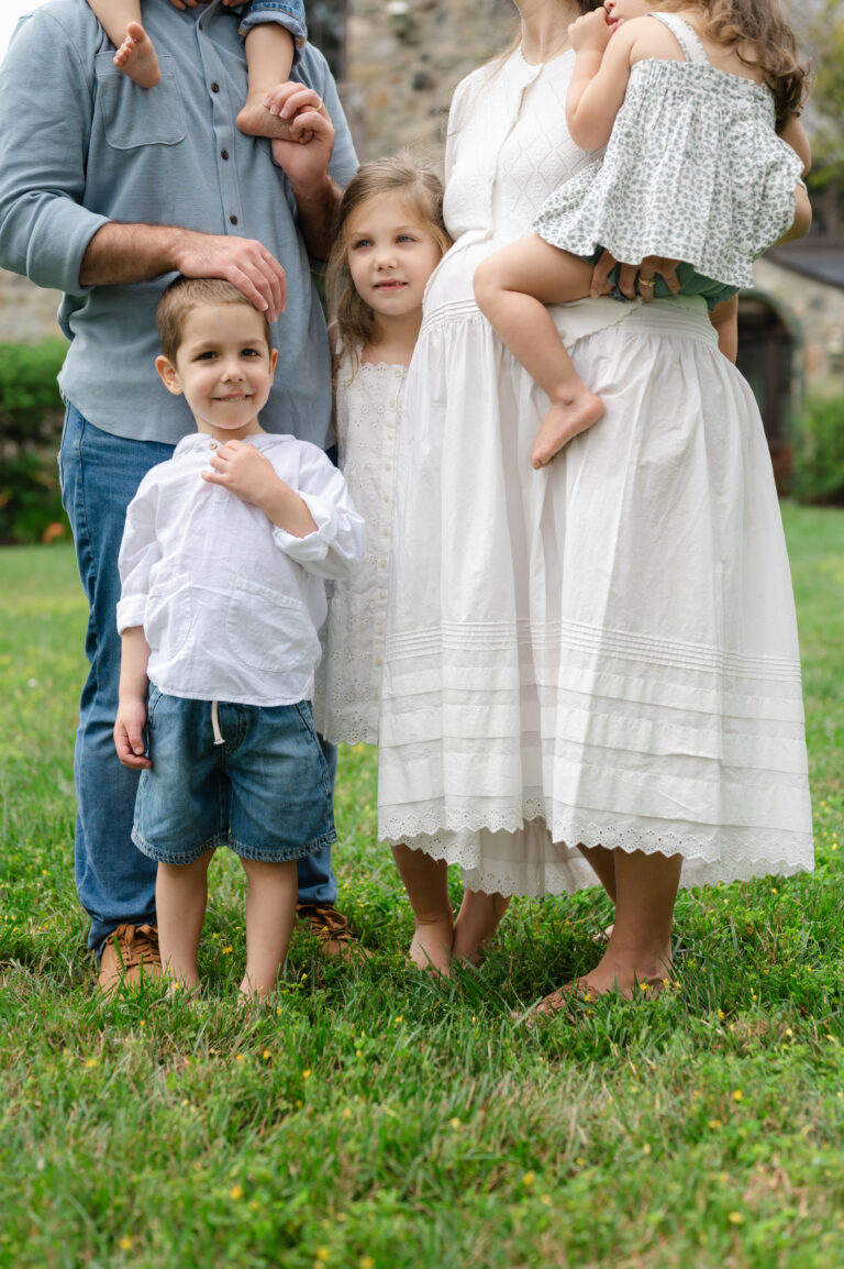 Large family crowds around expecting mom.