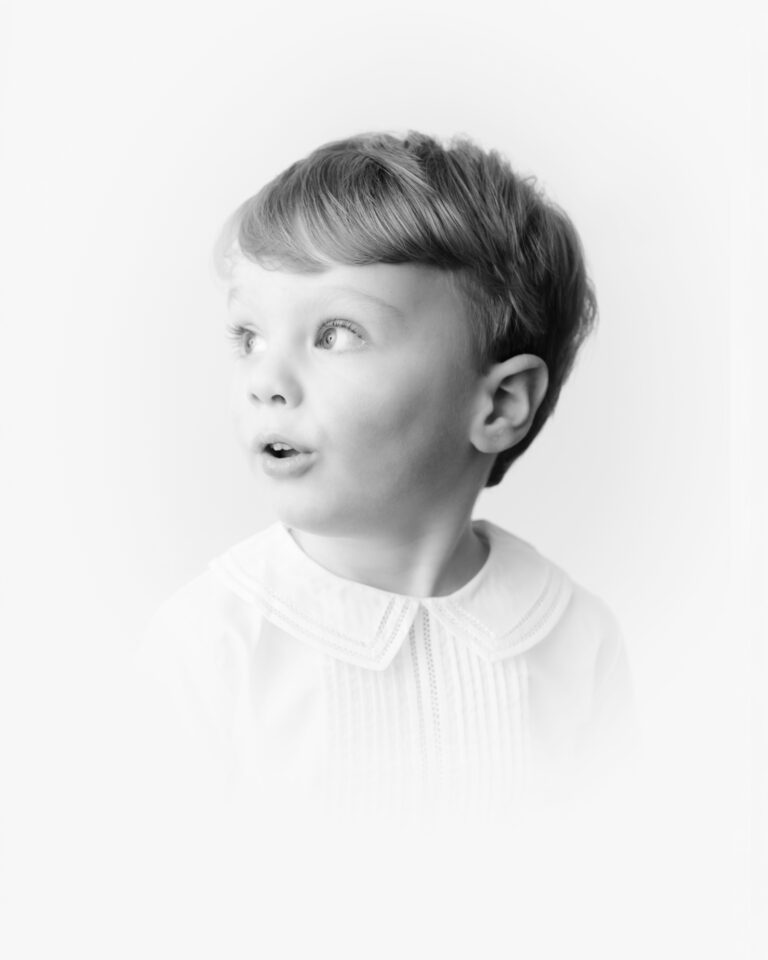 timeless children's heirloom portrait of a little boy in a white Peter pan collar.