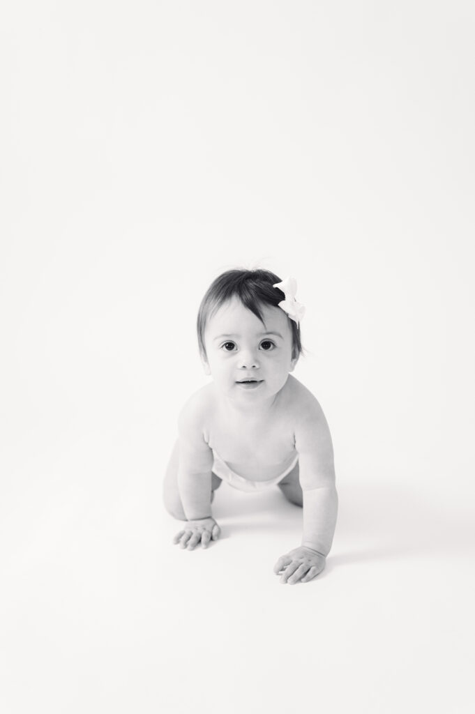 Baby girl sitting independently during a timeless milestone portrait session in Virginia